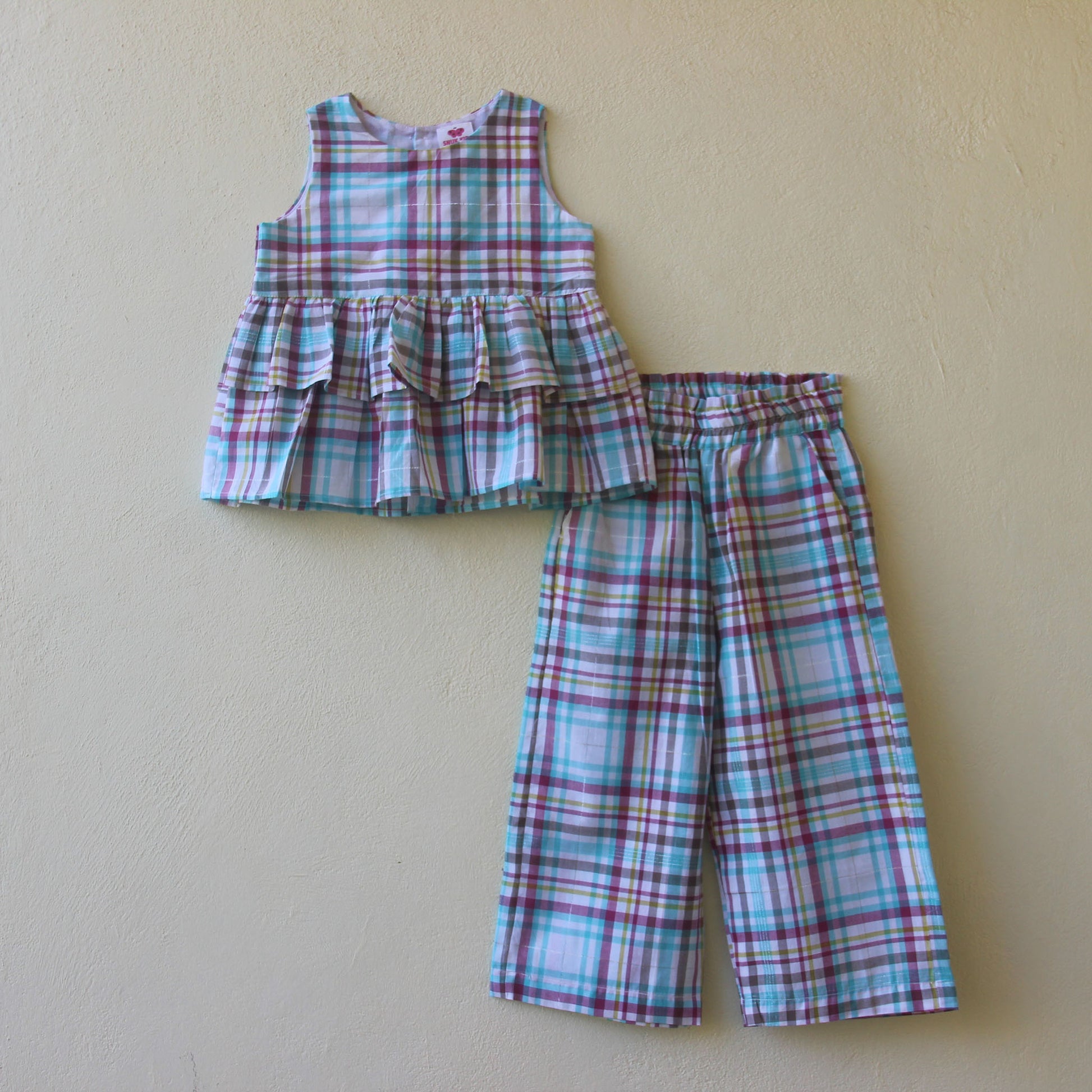 Plaid top and pants set on a beige background
