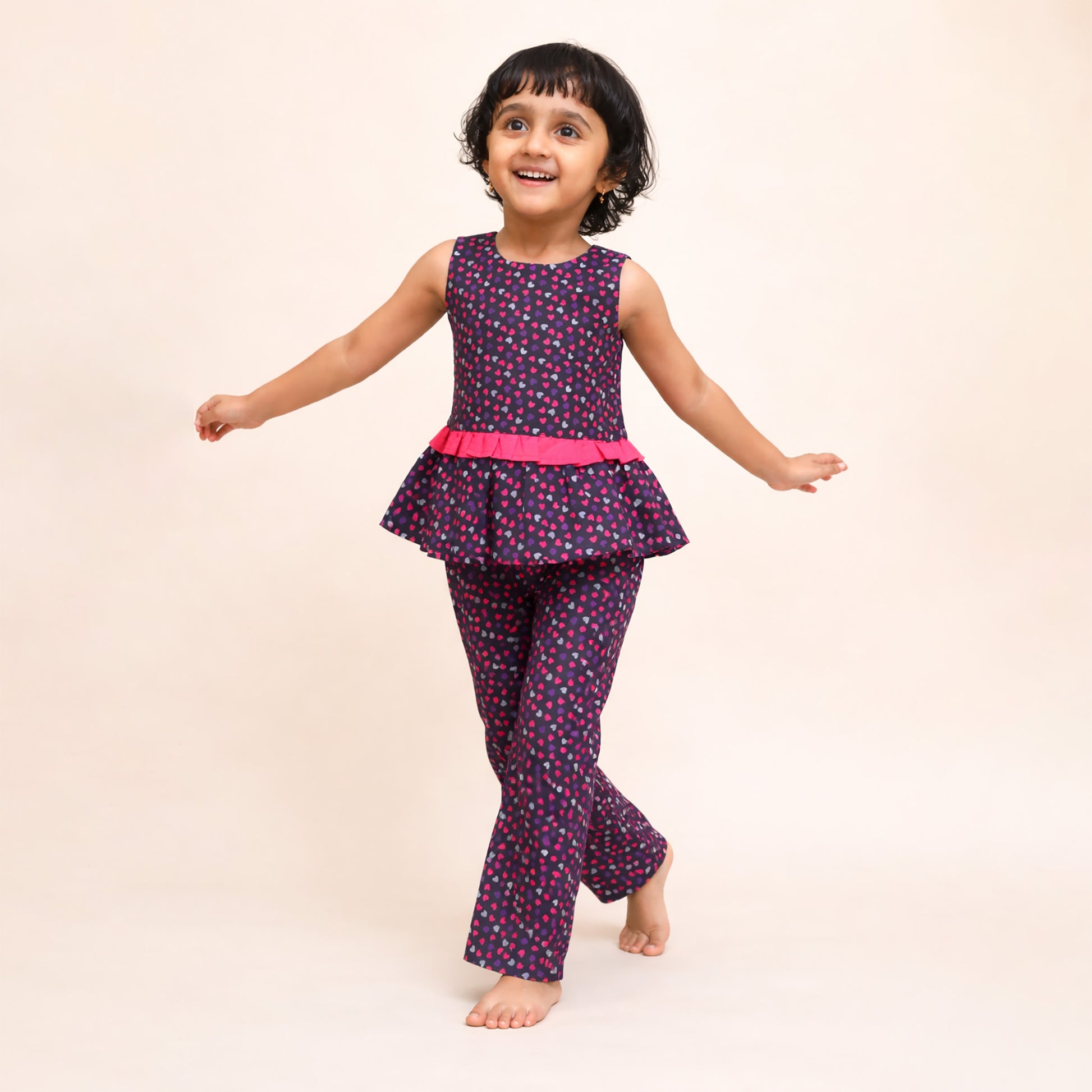 snukkids girls wearing black heart print peplum top and wide leg trousers set
