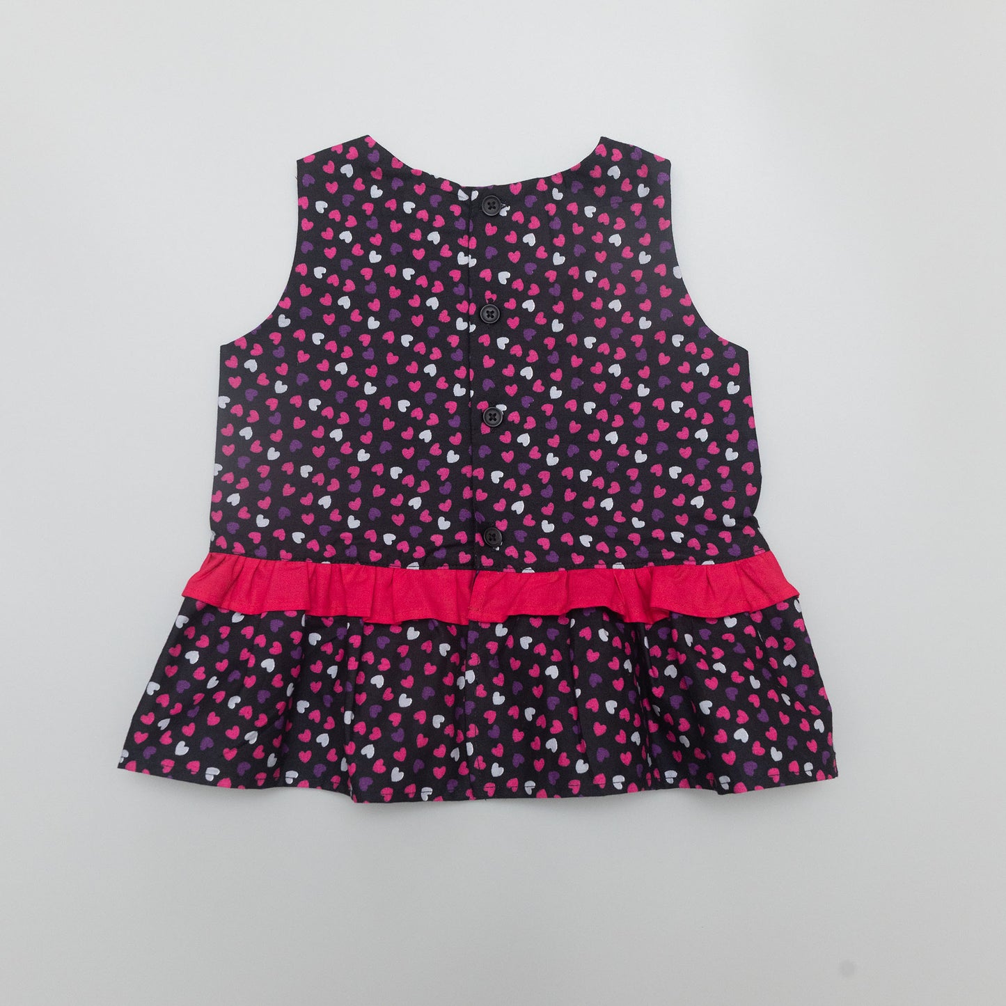 Children's dress with heart pattern.
