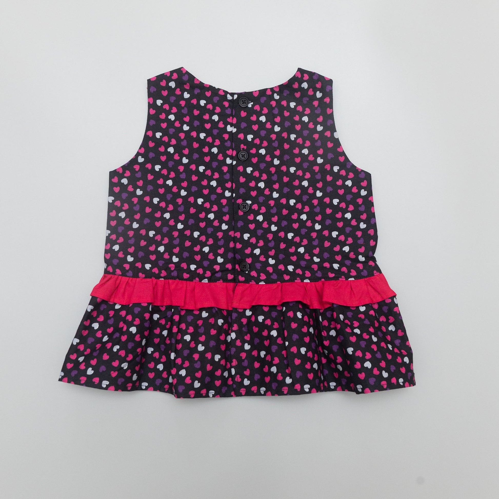 Children's dress with heart pattern.