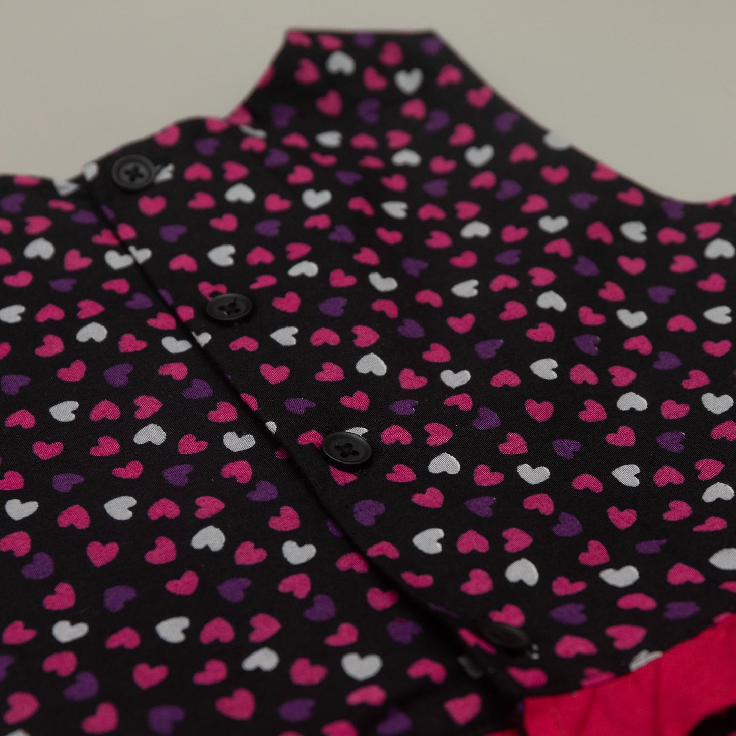 Close-up of a garment with a heart pattern on a plain background