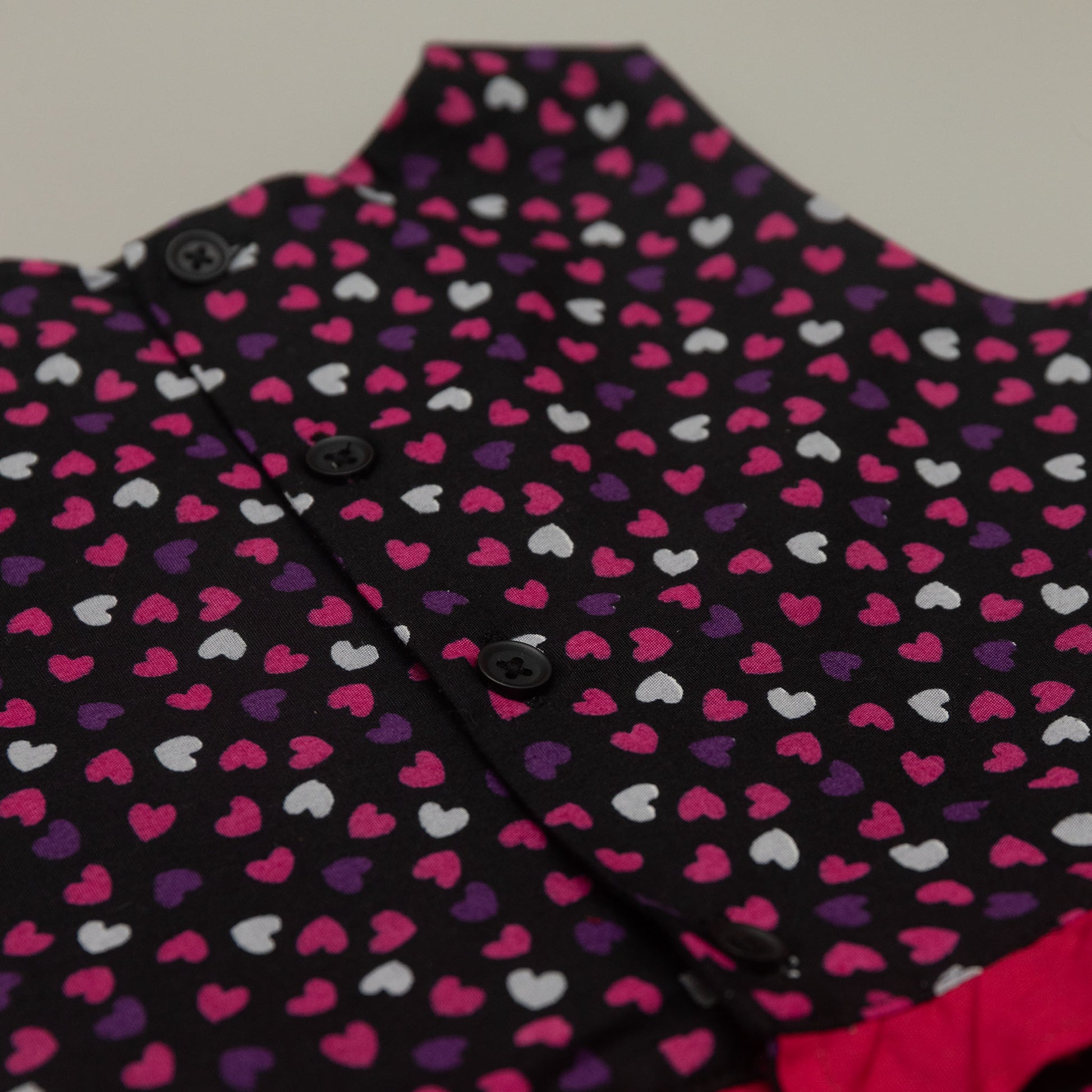 Close-up of a garment with a heart pattern on a plain background